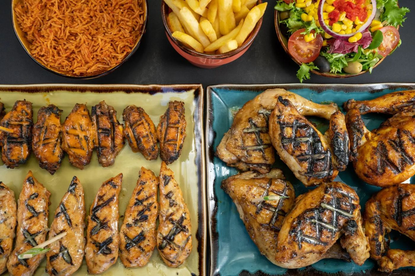 Trays of freshly grilled peri-peri chicken
